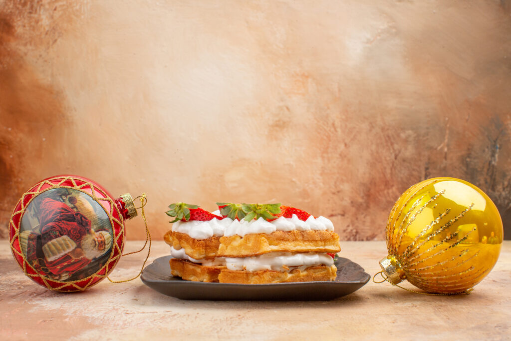 Sandwich on a plate with christmas ornaments surrounding it.